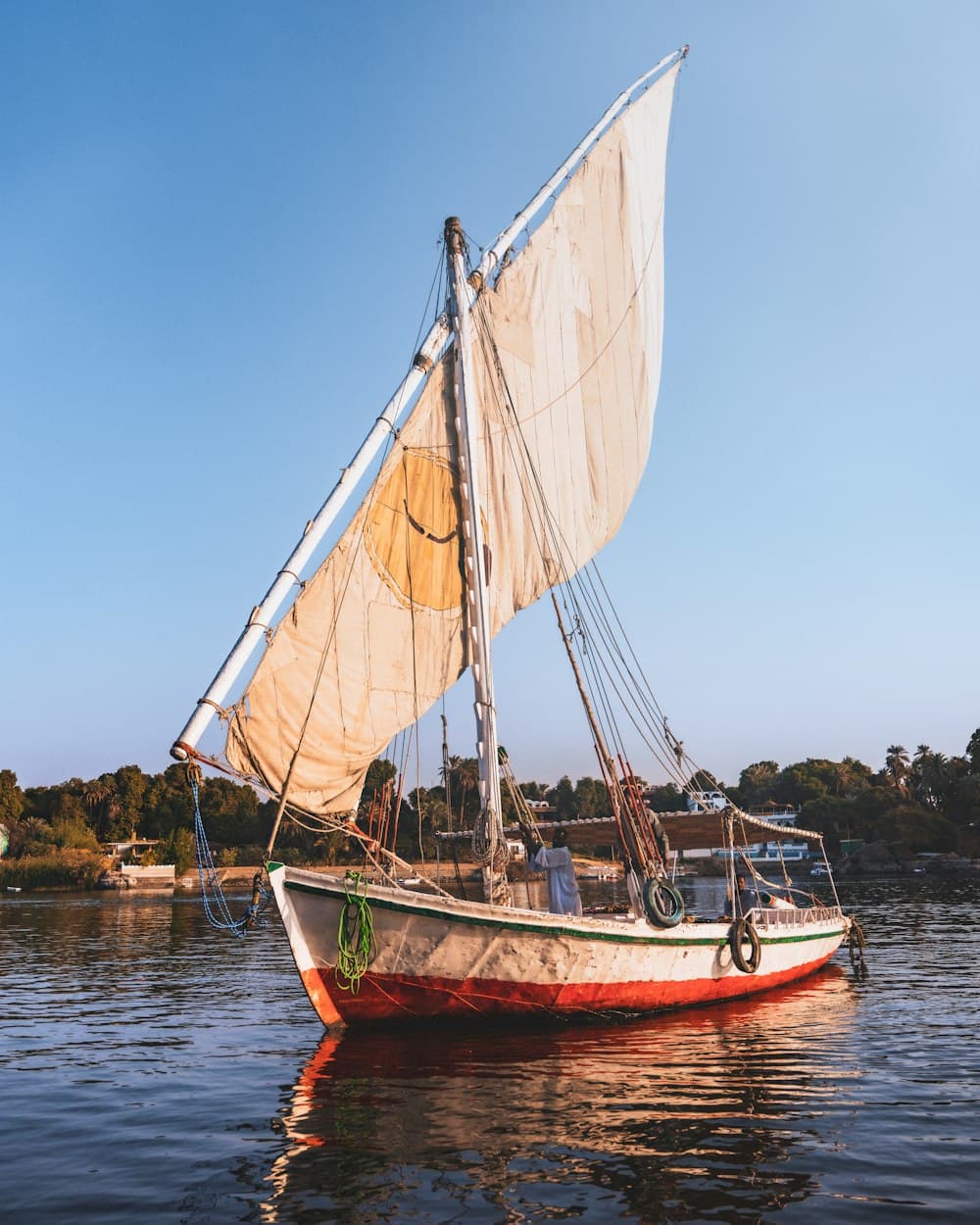 Traditional felucca with a raised sail on the Nile at Aswan