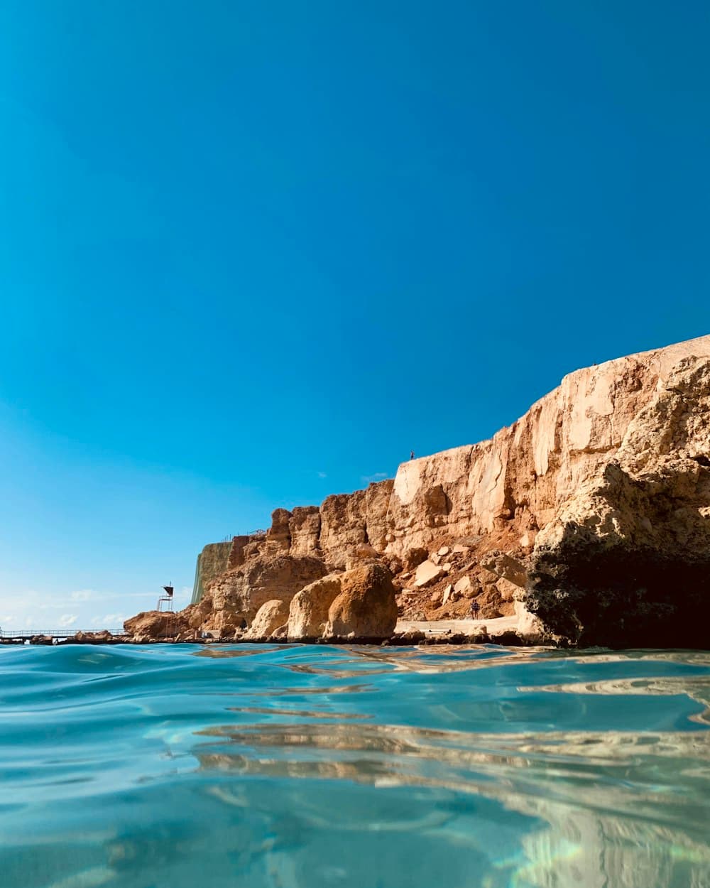 Rocky headland above clear turquoise water in Sharm El Sheikh